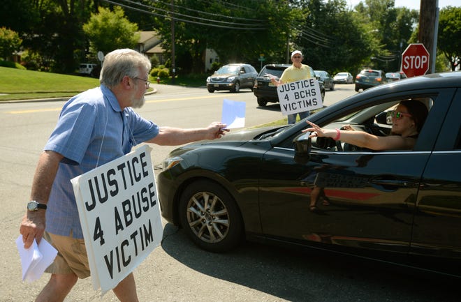 Protesters distribute leaflets in 2015 criticizing Bergen Catholic's handling of sex abuse allegations against Bothers Charles B. Irwin and John Chaney. Viorel Florescu / NorthJersey.com