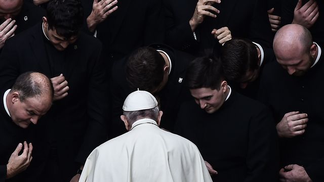 Pope Francis prays with priests at the end of a limited public audience at the San Damaso courtyard in The Vatican - Credit: AFP via Getty Images