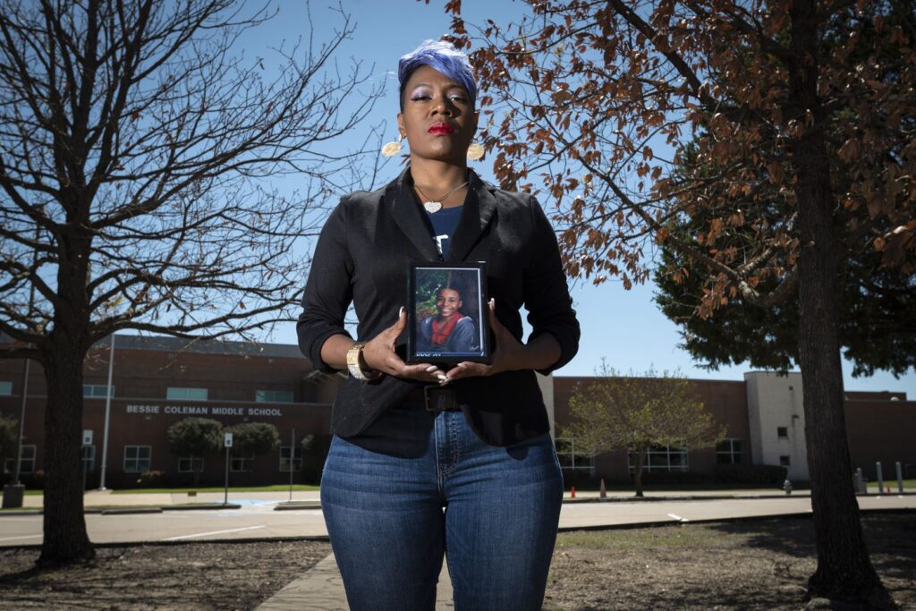 Donna Fields, holding a photo of son Marcus Bell Jr. when he was 12, stands outside Bessie Coleman Middle School in Cedar Hill, which Bell was attending when he says Pastor Rickie Rush sexually assaulted him in Rush’s office at Inspiring Body of Christ Church. “Rush needs to be held accountable,” Bell says. “He doesn’t need to be doing this to anybody else.”(Ben Torres / Special Contributor)