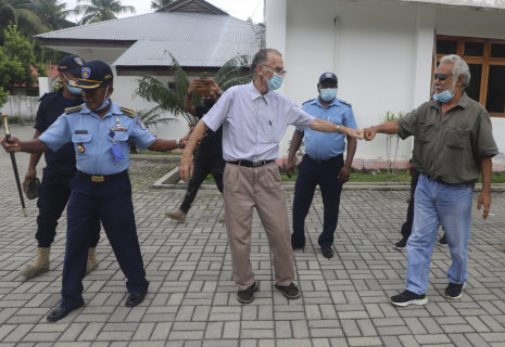 Xanana Gusmao, right, former East Timorese president and prime minister, gives a fist bump to Richard Daschbach, after a court hearing in Oecusse, East Timor, in February.CREDIT:AP