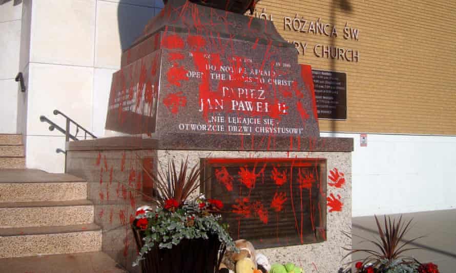 A statue of Pope John Paul II vandalized in Edmonton. Canada has been rocked by the discovery of nearly a thousand unmarked graves at the sites of church-run residential schools. Photograph: Canadian Press / Rex / Shutterstock