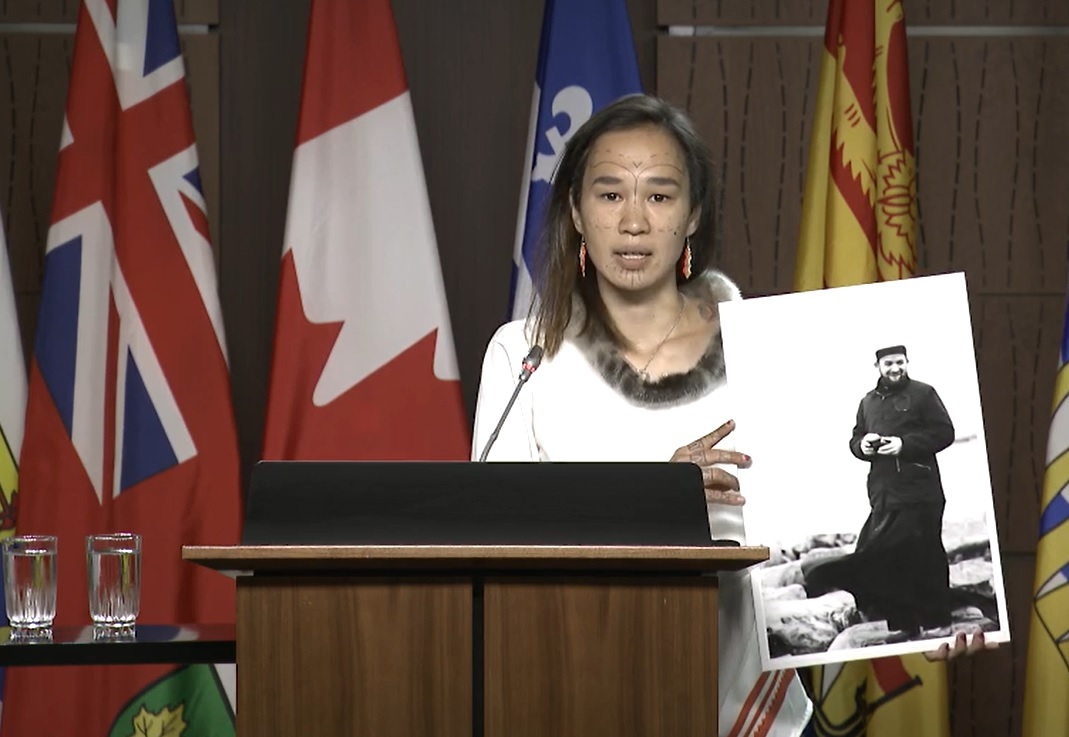 Nunavut MP Mumilaaq Qaqqaq holds a photo Thursday morning of French Oblate priest Joannis Rivoire, who is accused of sexually assaulting Inuit children who attended residential schools in Nunavut communities in the 1960s. The NDP is calling on the government to investigate Rivoire and other alleged perpetrators within the residential school system. (Screen grab courtesy of CPAC)