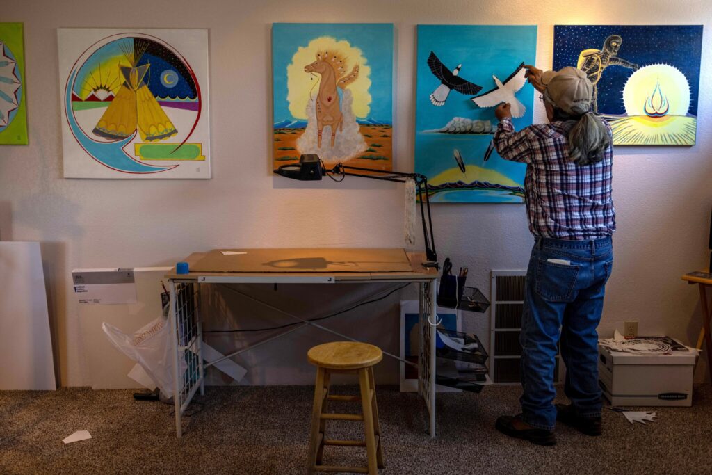 Russell Box Sr. spends his days at his home in Ignacio, Colo., painting images of Native American symbols and ceremonies he was told to forget at the boarding school he attended as a child.Credit...Sharon Chischilly for The New York Times