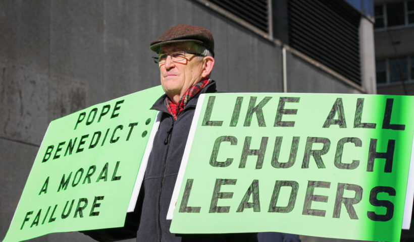 [Photo above: Former clergyman, Robert Hoatson, protests outside the Manhattan business offices of the Archdiocese of New York in support of sexual abuse victims. His goal is to “stir the pot” and put pressure on church leadership to acknowledge predatory behavior. New York, NY. Feb. 9, 2022. Danielle Dawson for NY City Lens]