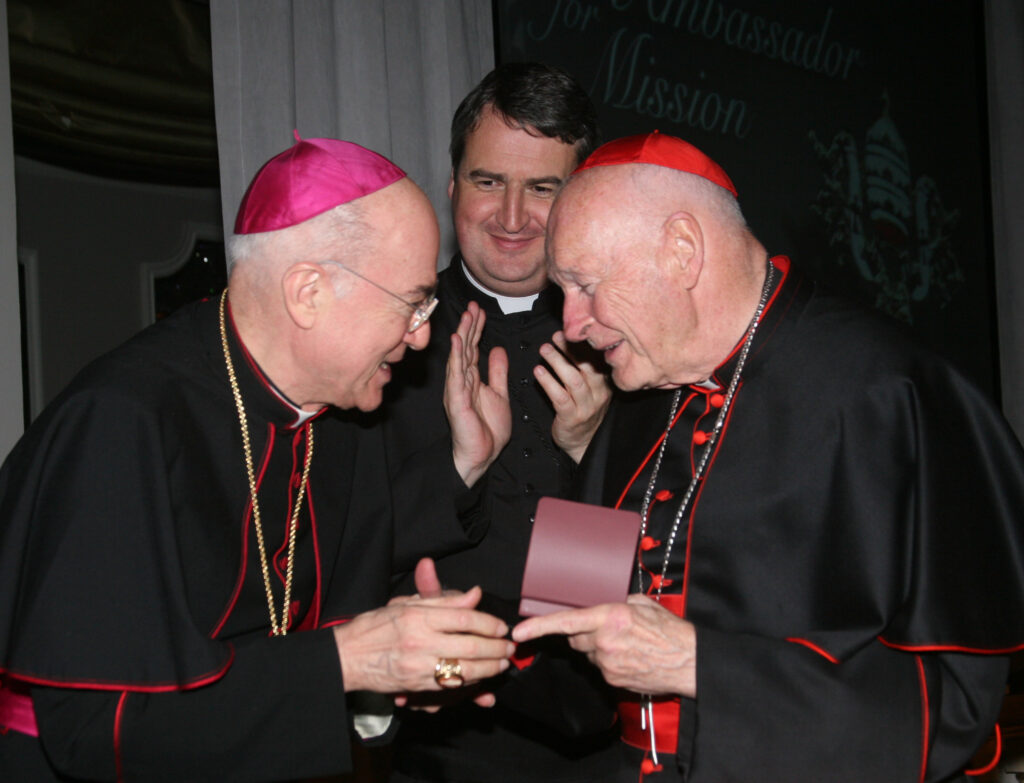 Archbishop Carlo Maria Vigano, then nuncio to the United States, congratulates then-Cardinal Theodore McCarrick of Washington at a gala dinner sponsored by the Pontifical Missions Societies in New York in May 2012. Vigano has been found guilty of schism and excommunicated, the Vatican announced July 5. (CNS/PMS/Michael Rogel)