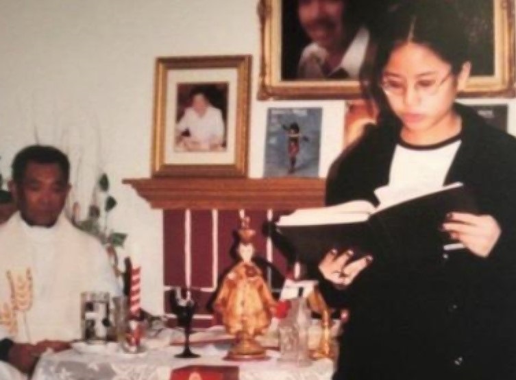 Aimee Torres, pictured in 1999, reads during a Mass celebrated by Fr. Honesto Bayranta Bismonte in her family's home. In 2002, Bismonte was arrested and charged with sexually molesting two young girls, including Torres. He pleaded guilty to misdemeanor battery and was sentenced to two years of informal probation in Los Angeles and was removed from active ministry. (Courtesy of Aimee Torres)