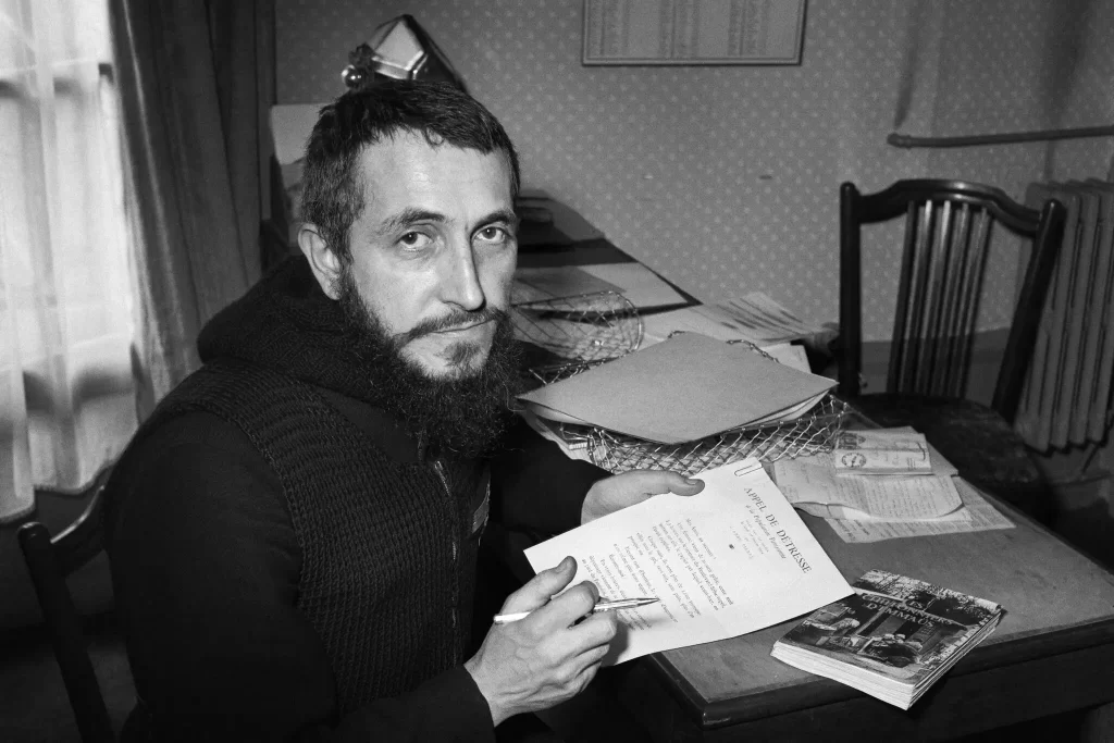 Abbé Pierre at his office in Paris in 1954. Credit...Agence France-Presse — Getty Images