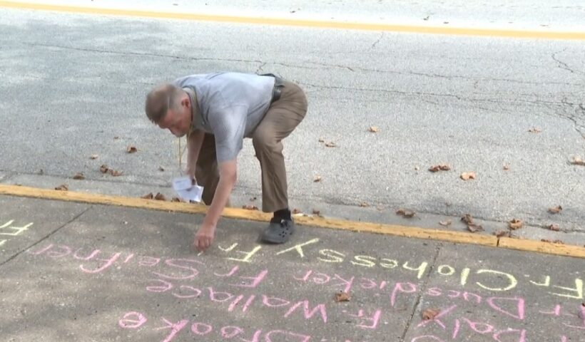 David Clohessy, Director of Missouri SNAP, writes the names of accused priests who worked in the Diocese of Jefferson City on the sidewalk in front of Immaculate Conception Church in Jefferson City MO on January 19, 2024.