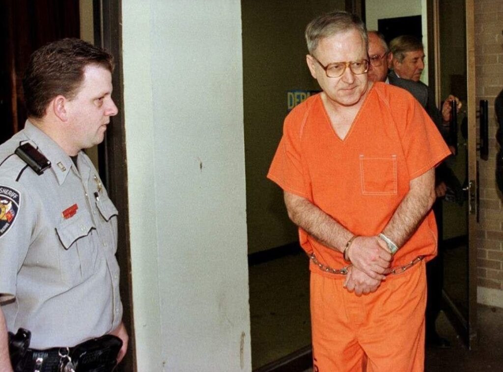 Former Catholic priest Gilbert Gauthe, who was convicted of child sexual abuse, is escorted out of the Lafayette Parish Courthouse after a hearing in 2000. File photo