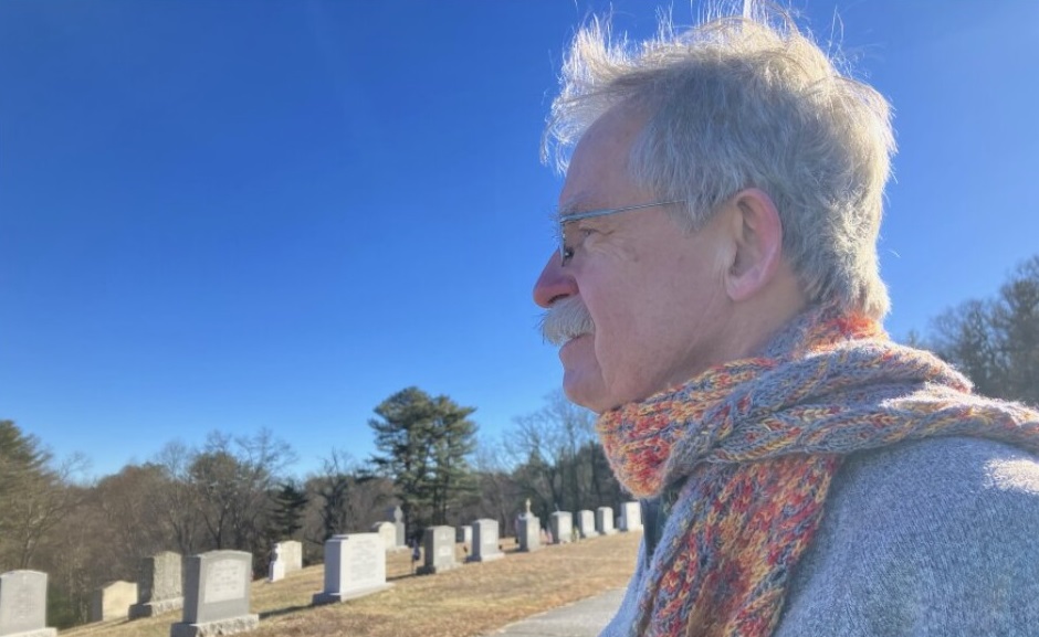 Terence McKiernan, president of BishopAccountability.org, visits the Douglas, Massachusetts, cemetery where Phil Saviano is buried. McKiernan helped arrange for Saviano, a survivor of abuse at the Worcester Diocese, to meet with investigators from the Massachusetts attorney general's office as part of their inquiry into the diocese. Nancy Eve Cohen / NEPM